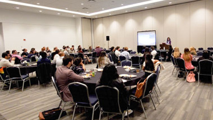 Students sit at tables and engage with a speaker at the SETAC Louisville meeting