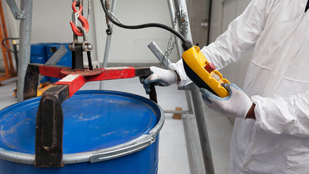 professional handling hazardous waste barrel